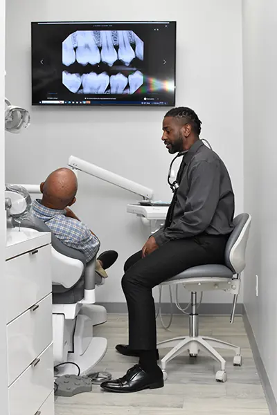 Dentist consulting with a patient in a treatment room